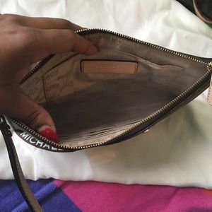 Uses Michael Kors Clutch